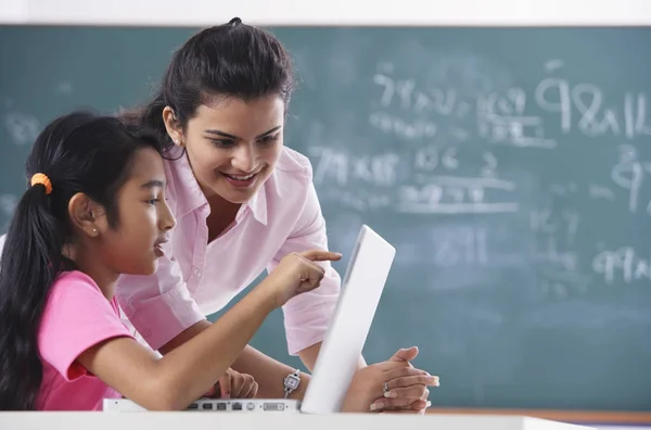 depositphotos 133649176 stock photo teacher and girl at laptop